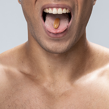 man taking a capsule