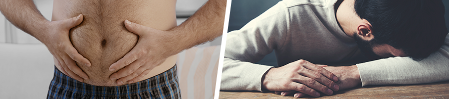 man touching his stomach and a man sleeping on table