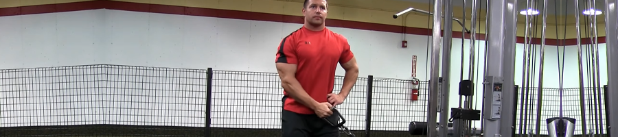 man using a cable machine in a gym