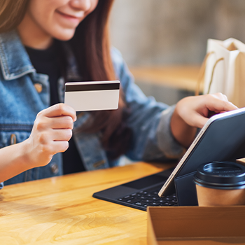 woman using pc and credit card