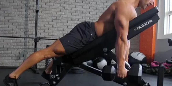 Performing a chest supported row inside a gym