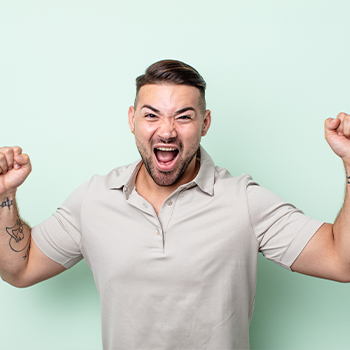 man with his arms up smiling