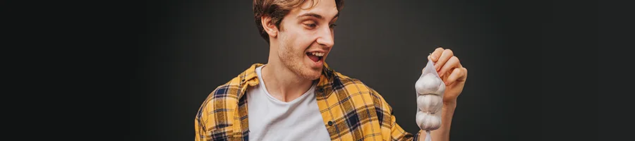 A man holding garlic up