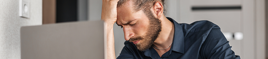 man holding his head in pain