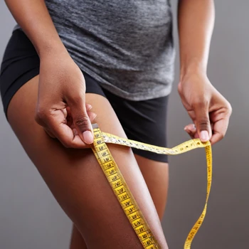 A woman measuring her inner thigh fat