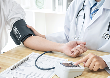 medical person checking a person's blood pressure