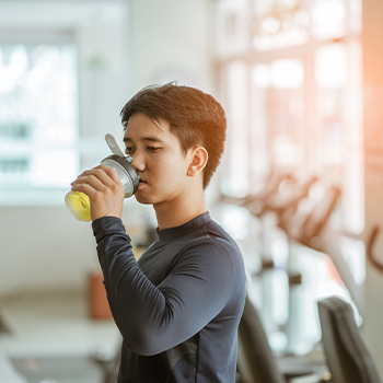 man taking a drink after workout