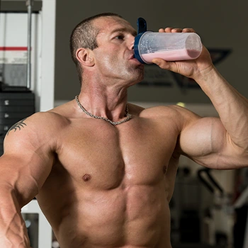 shirtless man drinking