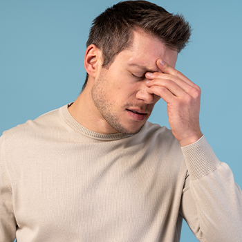 man holding his head in pain