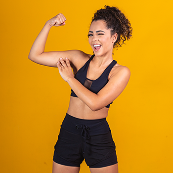 female in gym clothes showing her bicpes