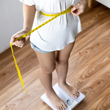 person measuring her body