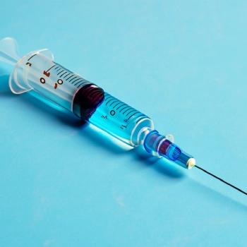 A syringe with possible transformation drugs placed on a table