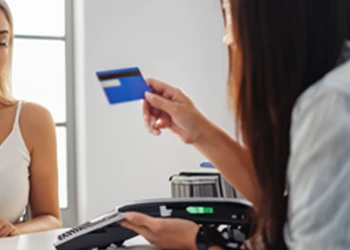 Woman holding a credit card buying