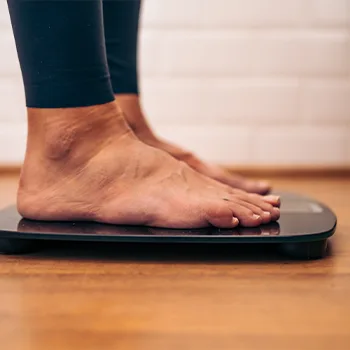 woman using a weighing scale