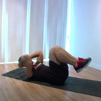 man in a tuck and crunch position