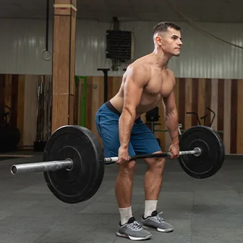 man lifting a barbell in a gym