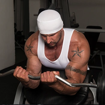 man in a ez preacher curls position