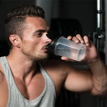 man chugging a jug of water