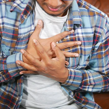 man holding his chest in pain