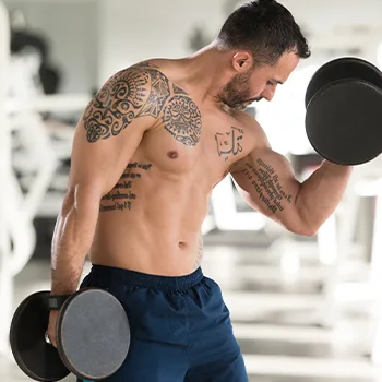 shirtless man using a dumbbell