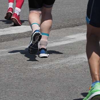 Close up shot of people running with Vans