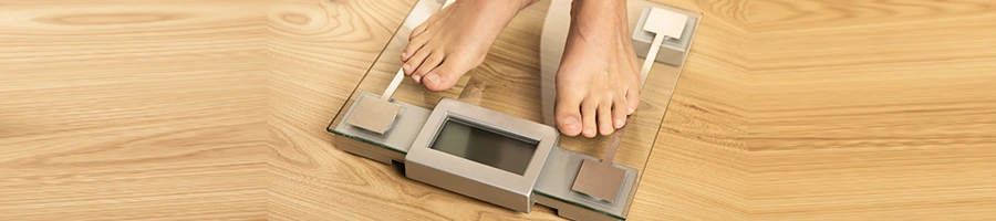 feet view of a person using a weighing scale