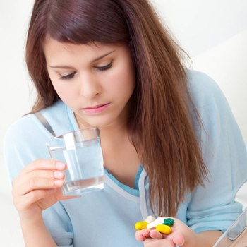 woman about to drink her medicines