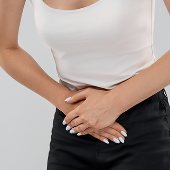 A woman holding her stomach from pain