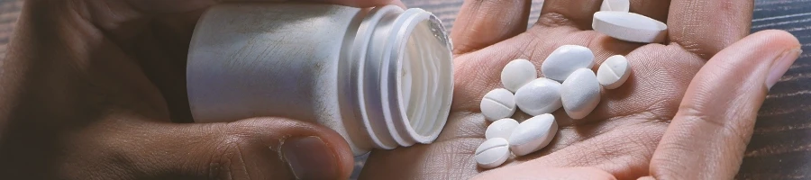 A person pouring anabolic drugs on the palm