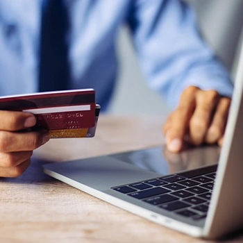 man using credit card and pc