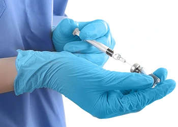 hand view of a person preparing a syringe