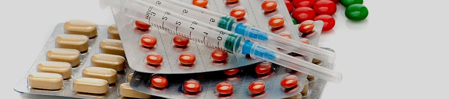 stack of capsules and syringe