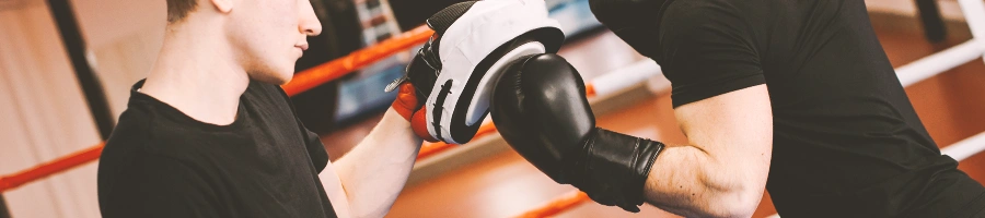 A man punching a mitt