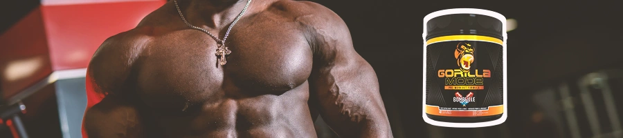 A very buff man standing in the gym