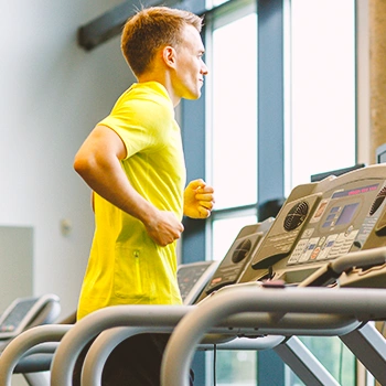 A fit man running on a treadmill