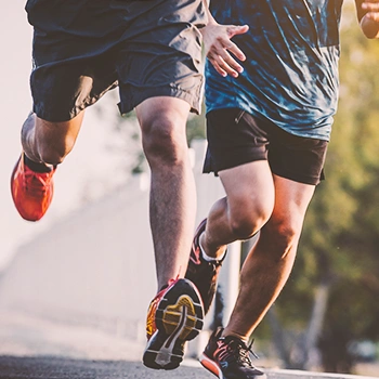 Two persons running outside