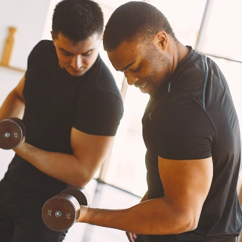 Two men lifting weights side by side