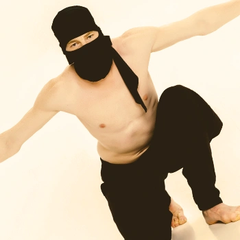 A topless ninja doing a pose