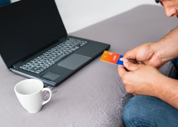 a man shopping online using his credit card