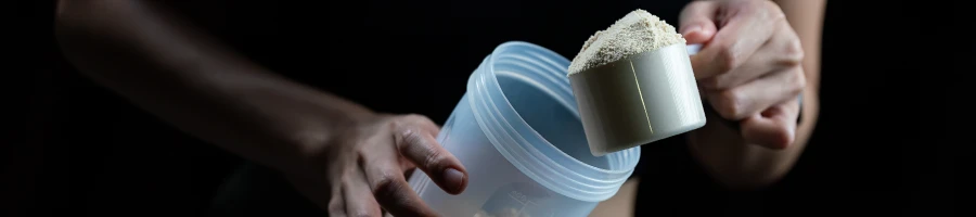 Pouring protein shake on a container