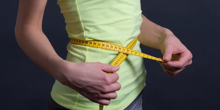 Using measuring tape around stomach