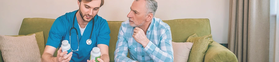 Two people looking at pill bottles