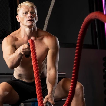 Naked man intense rope workout