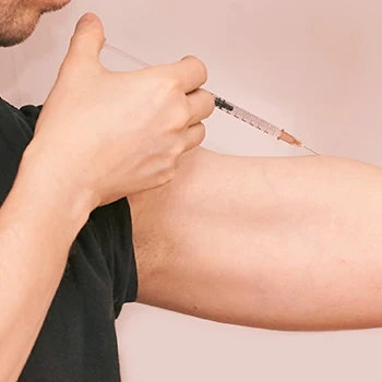 Injecting a syringe on muscle