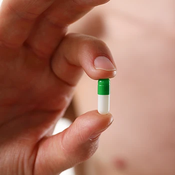 Close up image of a white and green pill