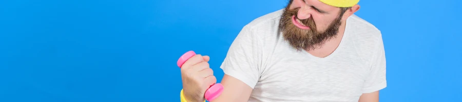 Man struggling lifting a small dumb bell