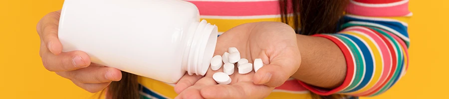 Teenager pouring pre workout supplement on hand