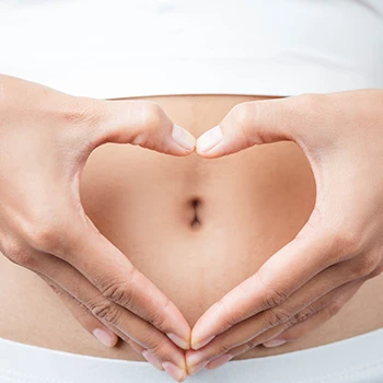 Forming a heart shaped hand on belly