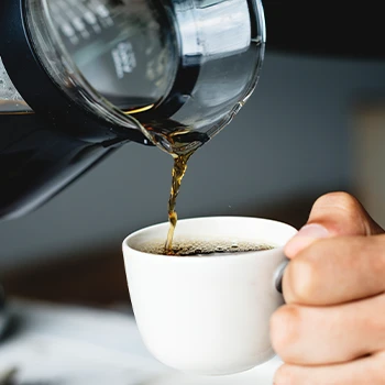 Pouring coffee on mug