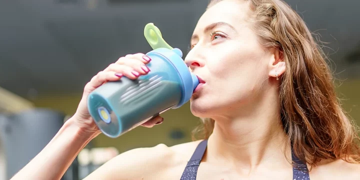 Woman drinking whey protein supplement